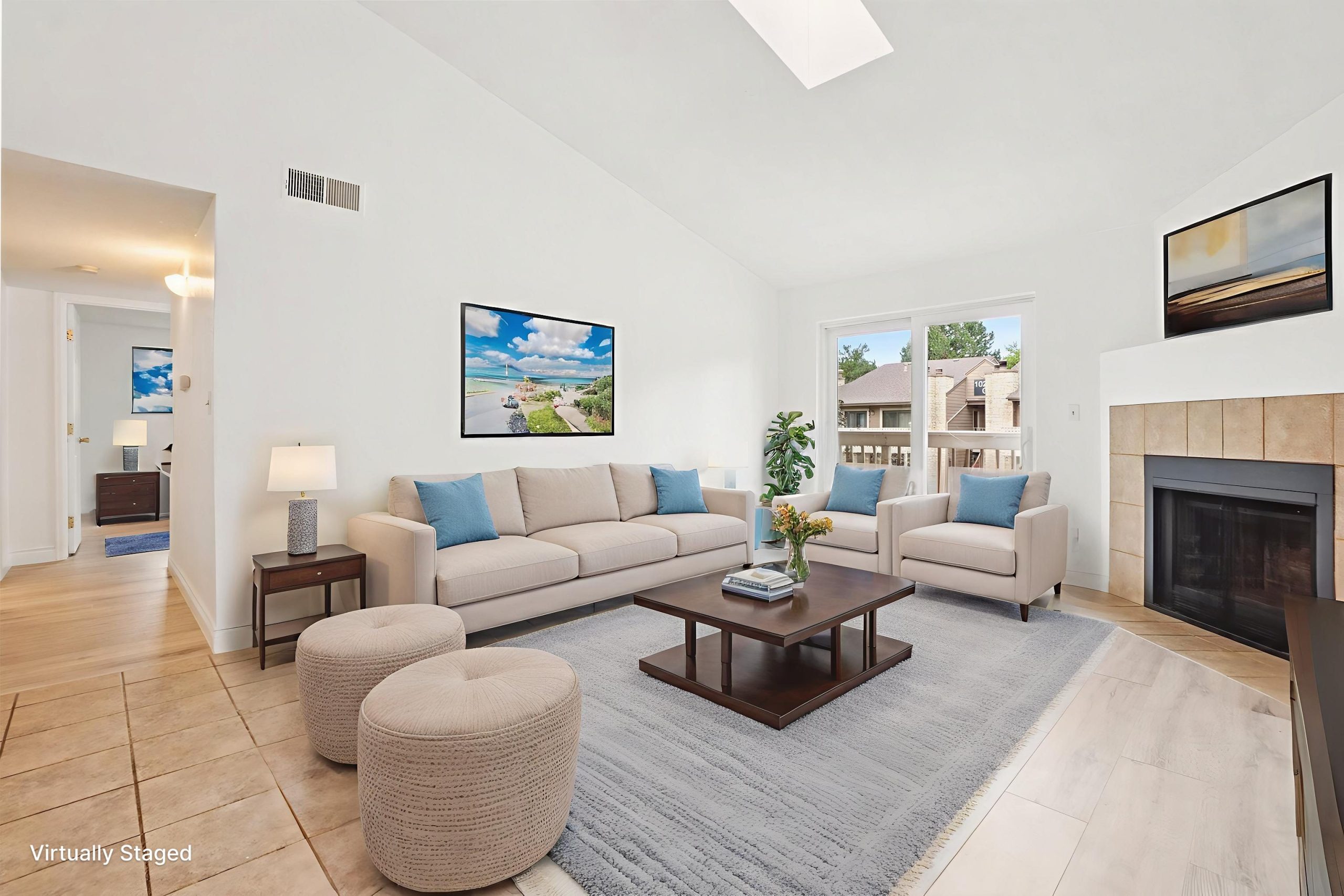Bright Englewood CO condo living room with new flooring, fresh paint, and cozy fireplace
