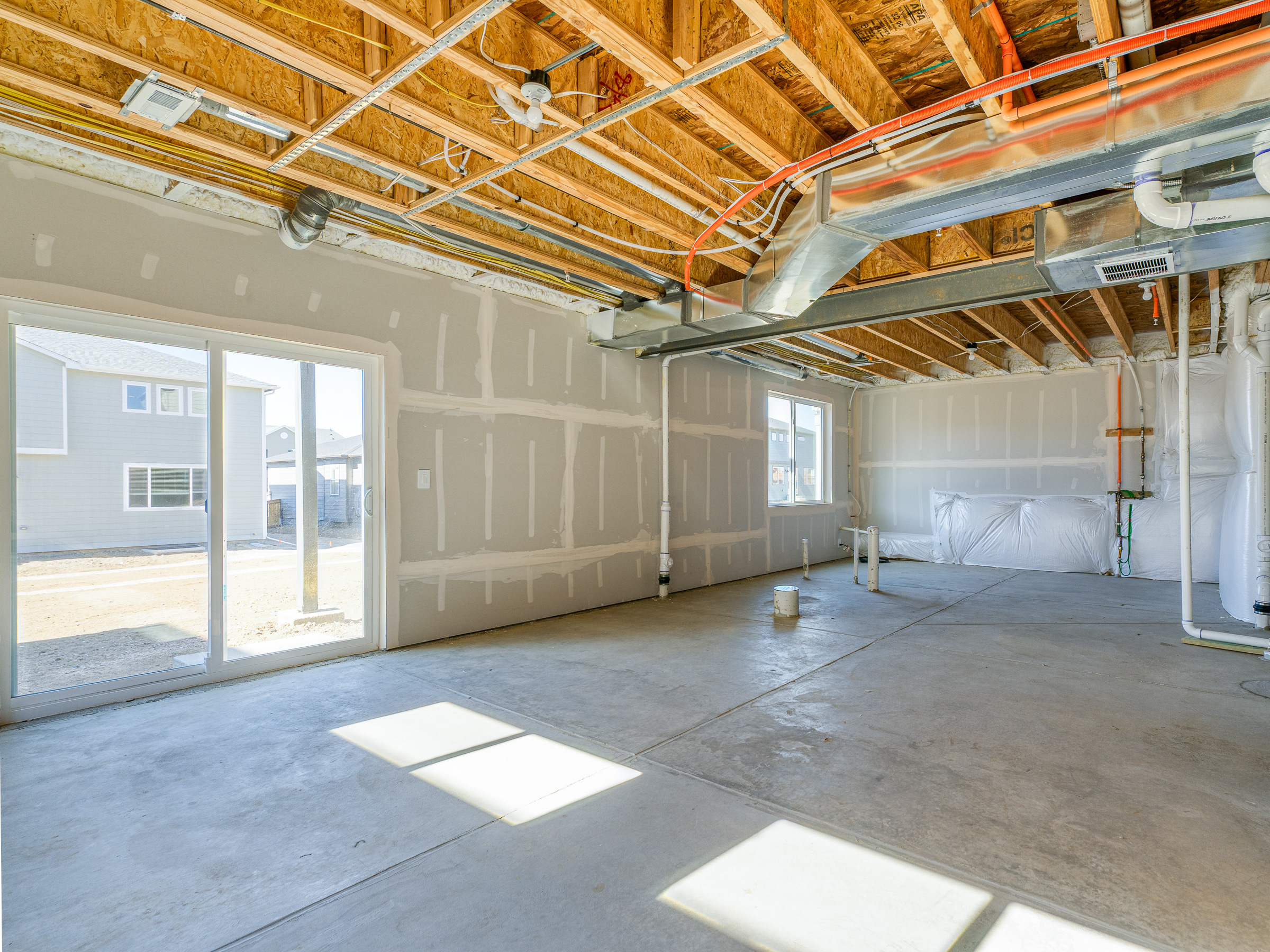 Walkout basement in new construction Silversage home in Buffalo Highlands Commerce City Colorado with sliding door to backyard